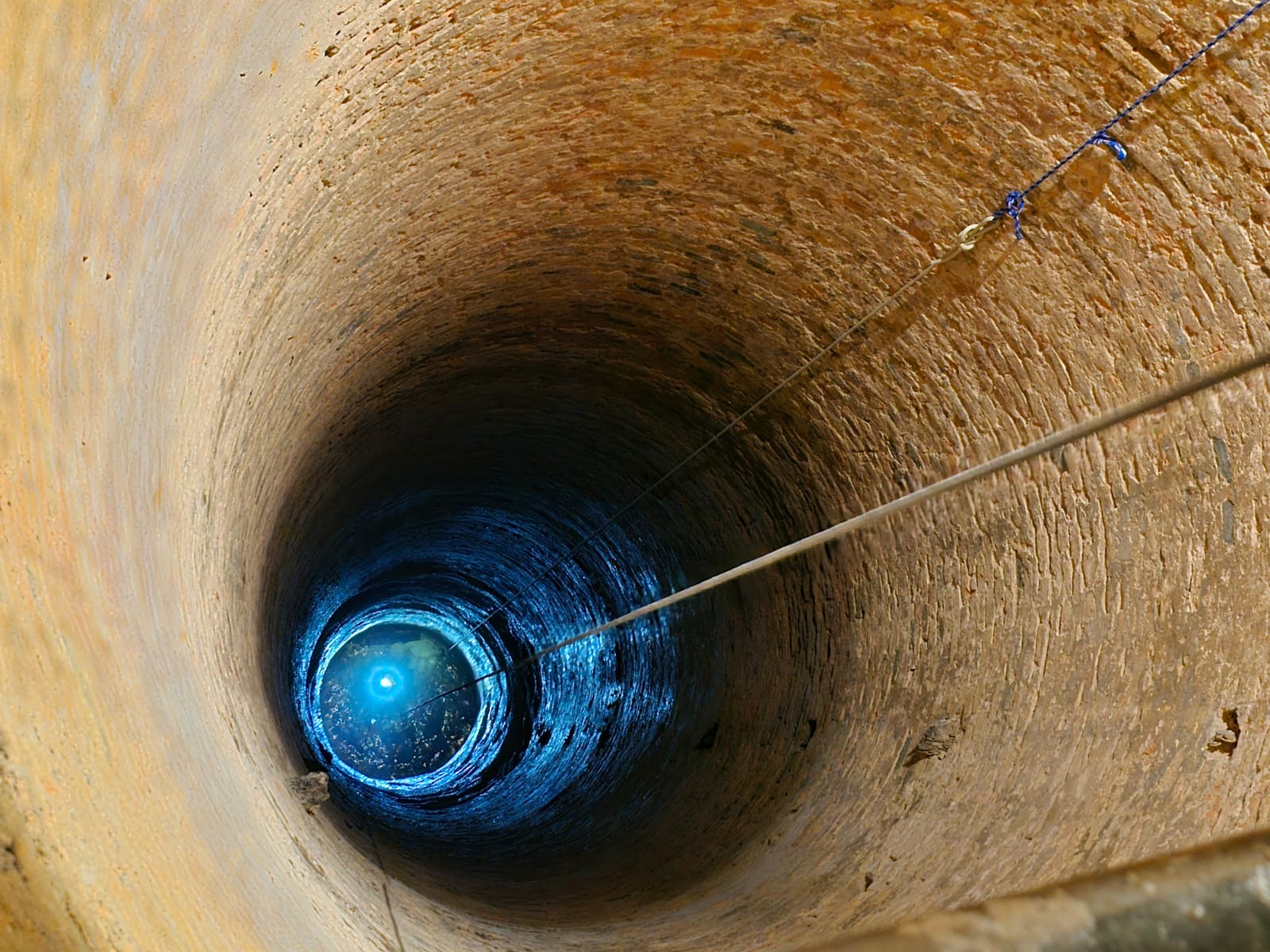 Looking straight down the brewery well shaft, ropes running into the dark