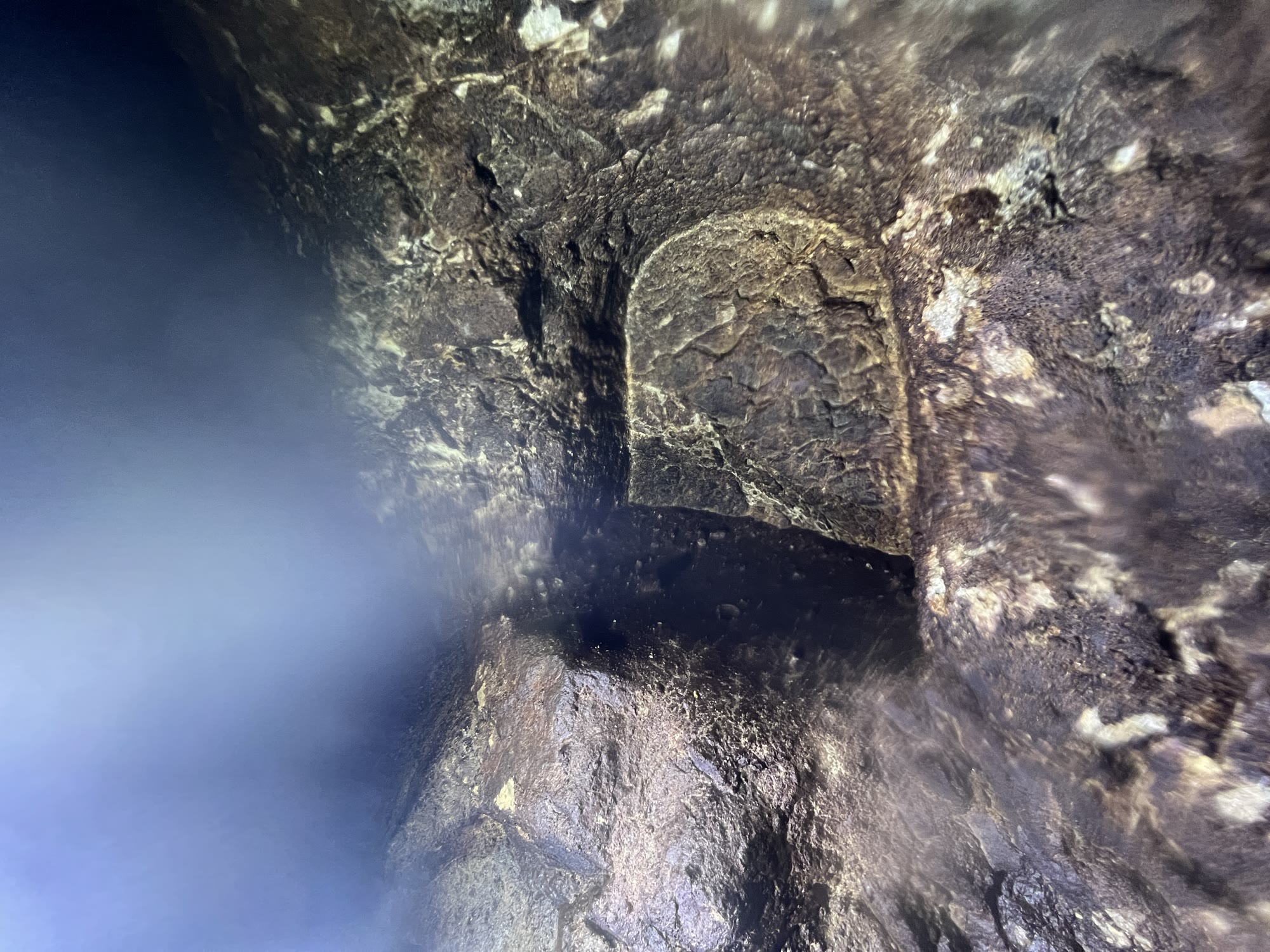 A small arched niche cut into the rock wall of the tunnel